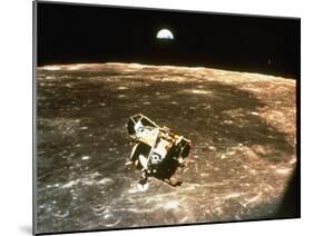 Apollo 11's Lunar Module Flying over the Moon with Earth in the Bkgrd-null-Mounted Photographic Print