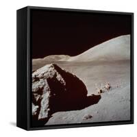 Apollo 17's Rover, a Lunar Vehicle, on the Surface of the Moon Next to Giant Rock-null-Framed Stretched Canvas