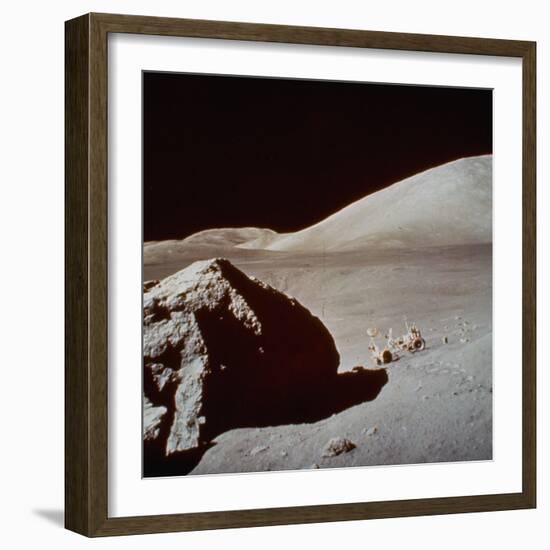 Apollo 17's Rover, a Lunar Vehicle, on the Surface of the Moon Next to Giant Rock-null-Framed Photographic Print