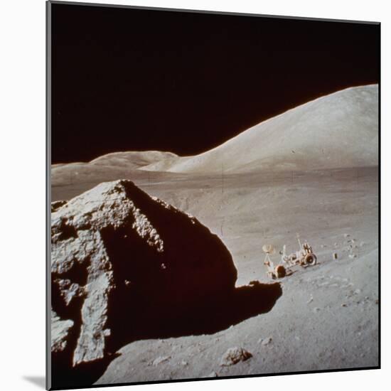 Apollo 17's Rover, a Lunar Vehicle, on the Surface of the Moon Next to Giant Rock-null-Mounted Photographic Print