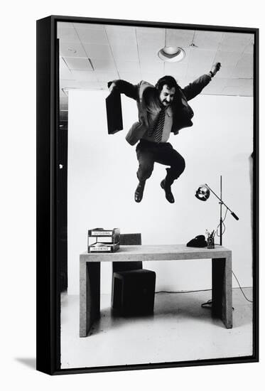 Architect and Designer Frank Gehry Jumping on a Desk in His Line of Cardboard Furniture-Ralph Morse-Framed Stretched Canvas