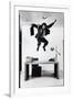 Architect and Designer Frank Gehry Jumping on a Desk in His Line of Cardboard Furniture-Ralph Morse-Framed Photographic Print