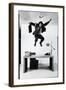 Architect and Designer Frank Gehry Jumping on a Desk in His Line of Cardboard Furniture-Ralph Morse-Framed Photographic Print