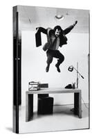 Architect and Designer Frank Gehry Jumping on a Desk in His Line of Cardboard Furniture-Ralph Morse-Stretched Canvas