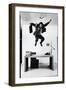 Architect and Designer Frank Gehry Jumping on a Desk in His Line of Cardboard Furniture-Ralph Morse-Framed Photographic Print