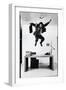 Architect and Designer Frank Gehry Jumping on a Desk in His Line of Cardboard Furniture-Ralph Morse-Framed Photographic Print