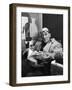 Architect Le Corbusier Sitting in Chair and Holding Book in Hands-Nina Leen-Framed Premium Photographic Print