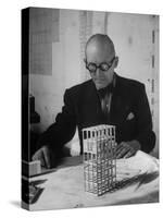 Architect Le Corbusier Studying Architectural Plans and Small Model of Building in His Office-Nina Leen-Stretched Canvas