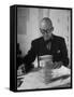 Architect Le Corbusier Studying Architectural Plans and Small Model of Building in His Office-Nina Leen-Framed Stretched Canvas