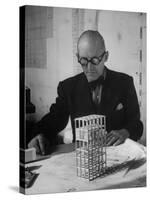 Architect Le Corbusier Studying Architectural Plans and Small Model of Building in His Office-Nina Leen-Stretched Canvas