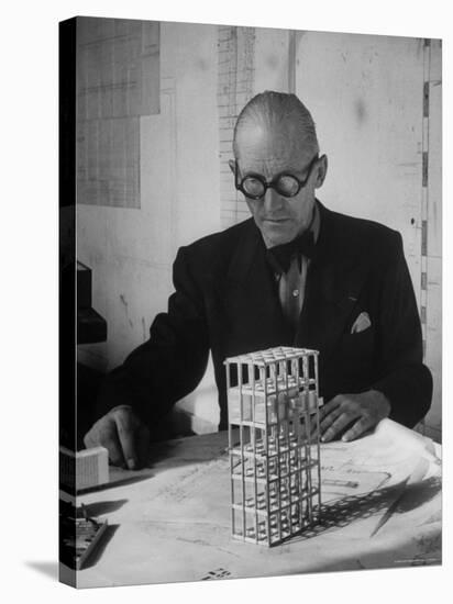 Architect Le Corbusier Studying Architectural Plans and Small Model of Building in His Office-Nina Leen-Stretched Canvas