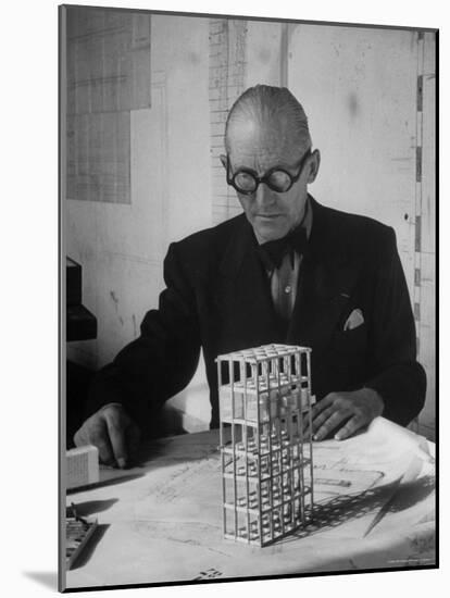 Architect Le Corbusier Studying Architectural Plans and Small Model of Building in His Office-Nina Leen-Mounted Premium Photographic Print
