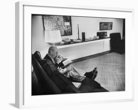 Architect Mies Van Der Rohe Relaxing on Couch While Smoking Cigar and Reading at Home-null-Framed Premium Photographic Print