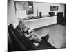 Architect Mies Van Der Rohe Relaxing on Couch While Smoking Cigar and Reading at Home-null-Mounted Premium Photographic Print