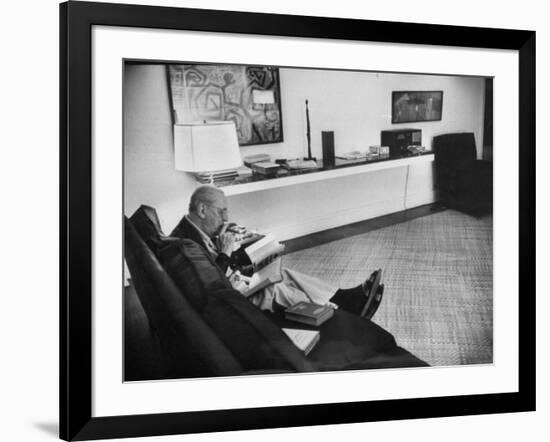 Architect Mies Van Der Rohe Relaxing on Couch While Smoking Cigar and Reading at Home-null-Framed Premium Photographic Print