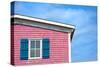 Architecture Detail of a Pink House with Blue Shuttered Window against Blue Sky-pink candy-Stretched Canvas