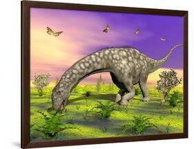 Argentinosaurus Eating Plants While Surrounded by Butterflies and Flowers-null-Framed Art Print