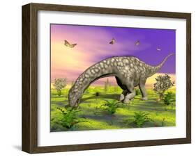 Argentinosaurus Eating Plants While Surrounded by Butterflies and Flowers-null-Framed Art Print