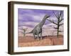 Argentinosaurus Standing on the Cracked Desert Ground Next to Dead Trees-null-Framed Art Print