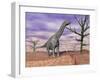 Argentinosaurus Standing on the Cracked Desert Ground Next to Dead Trees-null-Framed Art Print