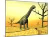 Argentinosaurus Standing on the Cracked Desert Ground Next to Dead Trees-null-Mounted Art Print