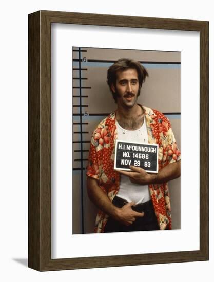 Arizona Junior RAISING ARIZONA by Joel Coen and Ethan Coen with Nicolas Cage, 1987 (photo)-null-Framed Photo