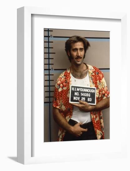 Arizona Junior RAISING ARIZONA by Joel Coen and Ethan Coen with Nicolas Cage, 1987 (photo)-null-Framed Photo