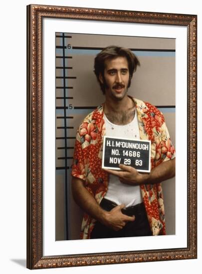 Arizona Junior RAISING ARIZONA by Joel Coen and Ethan Coen with Nicolas Cage, 1987 (photo)-null-Framed Photo