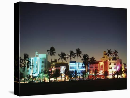 Art Deco Hotels at Dusk, Miami Beach, Florida, USA-Walter Bibikow-Stretched Canvas