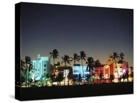 Art Deco Hotels at Dusk, Miami Beach, Florida, USA-Walter Bibikow-Stretched Canvas