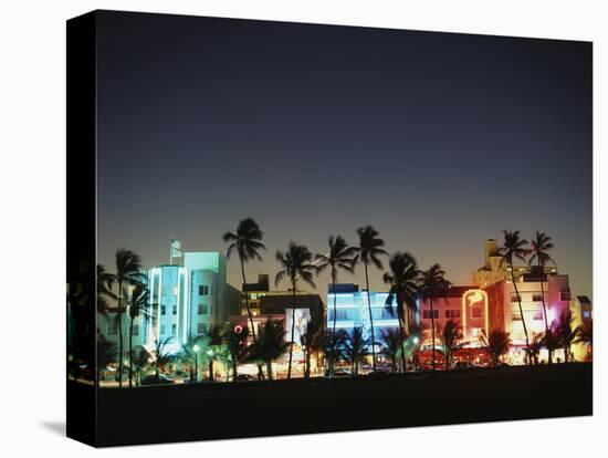 Art Deco Hotels at Dusk, Miami Beach, Florida, USA-Walter Bibikow-Stretched Canvas