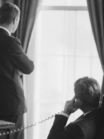 Pres. John F. Kennedy on Telephone While Brother, Attorney General Robert F. Kennedy Stands Nearby