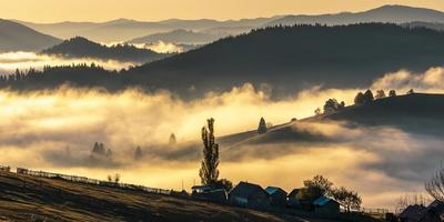 Misty farmland and mountains, Romania