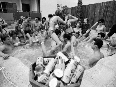 Pair of Couples "Chicken Fighting" in a Crowded Jacuzzi Pool During a Beer Fueled Party