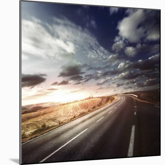 Asphalt Road in Field Against Moody Clouds at Sunset, Tuscany, Italy-null-Mounted Photographic Print