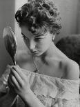 Joan Collins Studies Her Reflection-Associated Newspapers-Photo