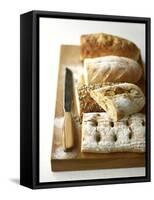 Assorted Loaves on Wooden Chopping Board-Michael Paul-Framed Stretched Canvas