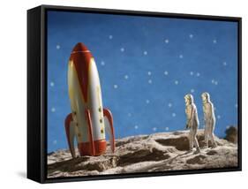 Astronaut Figurines Standing Beside Toy Rocket-null-Framed Stretched Canvas