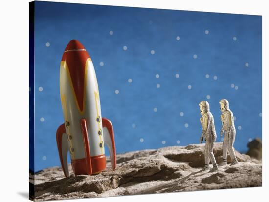 Astronaut Figurines Standing Beside Toy Rocket-null-Stretched Canvas
