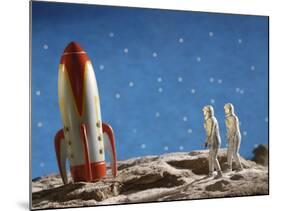 Astronaut Figurines Standing Beside Toy Rocket-null-Mounted Photographic Print