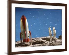 Astronaut Figurines Standing Beside Toy Rocket-null-Framed Photographic Print