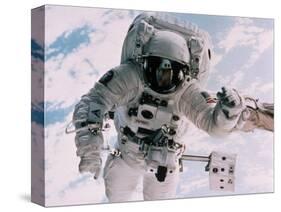 Astronaut Walking in Space-David Bases-Stretched Canvas