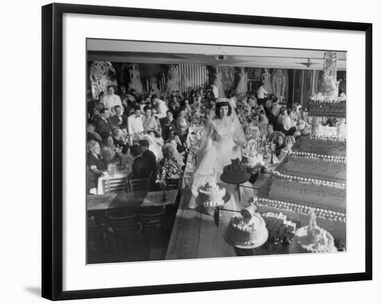 At Palumbo's Cafe, Bride Mrs. Salvatore Cannella Walks Onto Stage, Facing a Revolving Cake Display-Cornell Capa-Framed Photographic Print