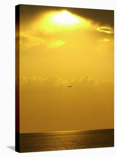 At Sunset a Commerical Jet Makes its Approach to Louis Armstrong New Orleans International Airport-null-Stretched Canvas