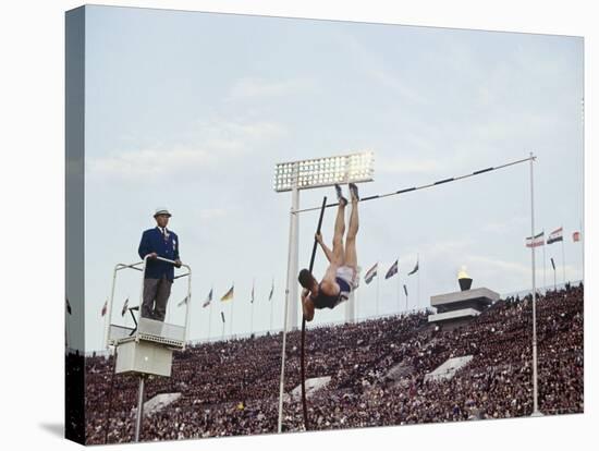 Athlete Clearing the Pole Vault at Summer Olympics-John Dominis-Stretched Canvas