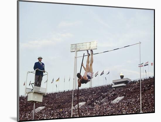 Athlete Clearing the Pole Vault at Summer Olympics-John Dominis-Mounted Photographic Print