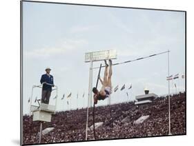 Athlete Clearing the Pole Vault at Summer Olympics-John Dominis-Mounted Photographic Print