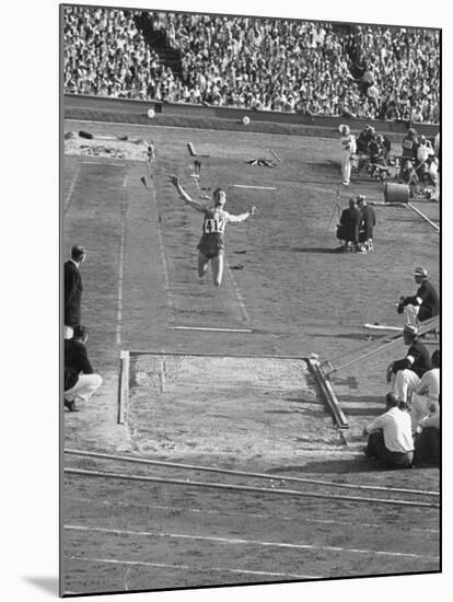 Athlete Competing in Long Jump-null-Mounted Premium Photographic Print