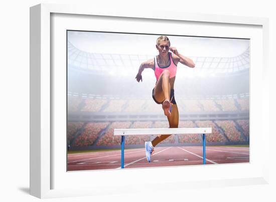 Athletic Woman Practicing Show Jumping against View of a Stadium-vectorfusionart-Framed Photographic Print