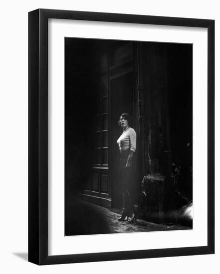 Atmospheric of Parisienne Prostitute Standing Near Doorway on Street-Alfred Eisenstaedt-Framed Photographic Print